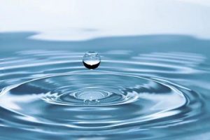 water droplet dropping onto water